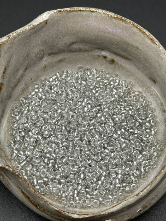 Small container filled with grey silver lined seed beads