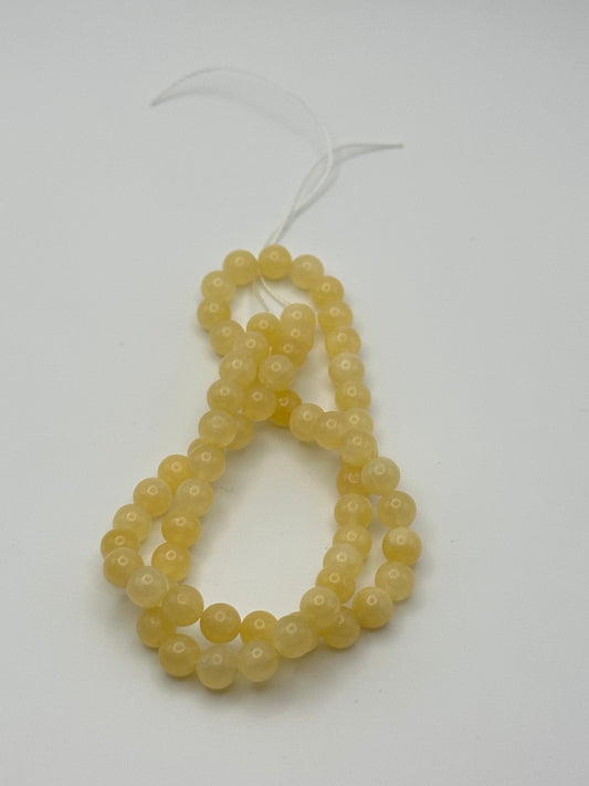 String of yellow beads on a white background