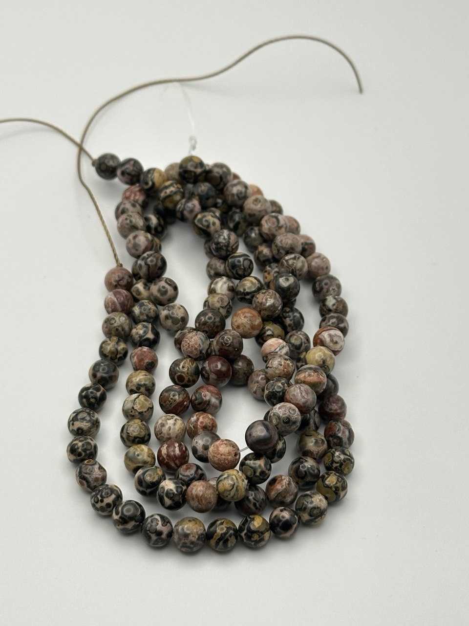 String of multicolored beads on a white background