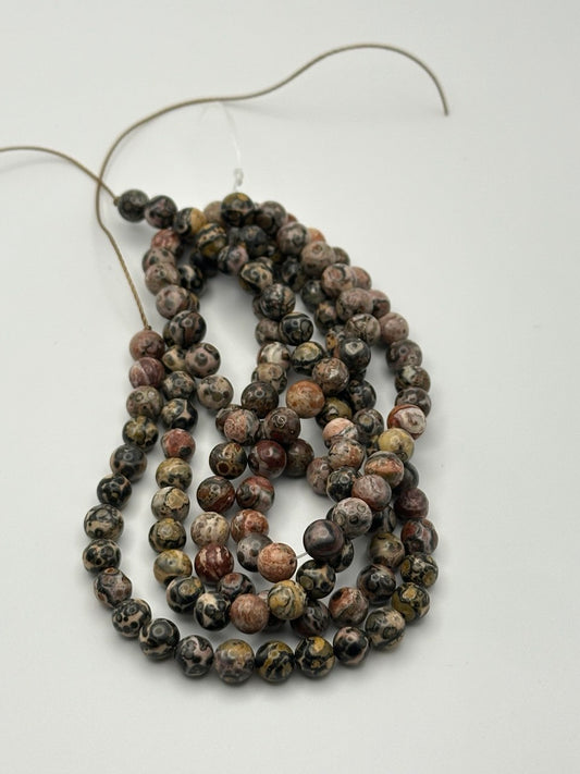 String of multicolored beads on a white background
