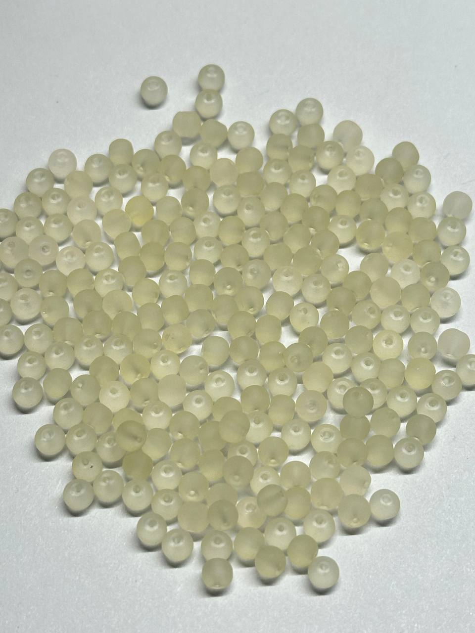 Light yellow beads on a white background