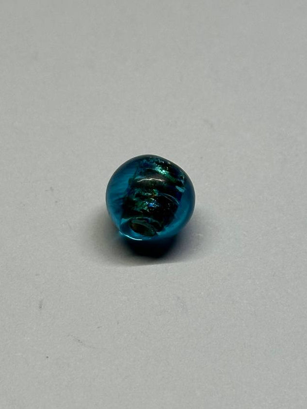 Blue metallic bead on a gray background