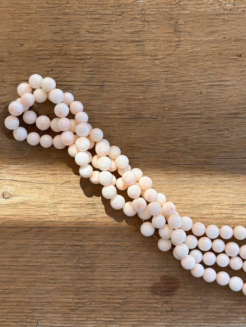 String of botswana agate beads on wooden surface