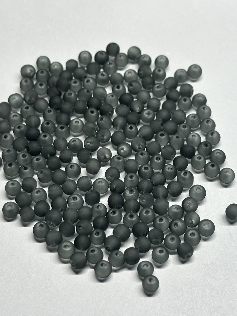 Large quantity of grey beads on a white background