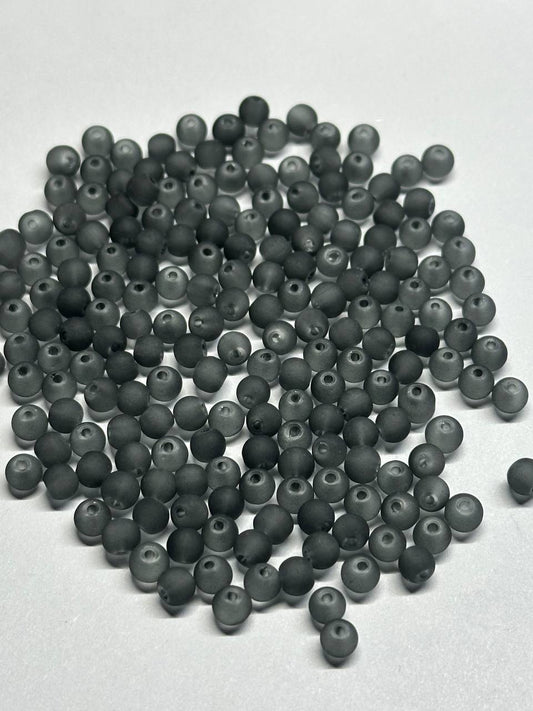 Large quantity of grey beads on a white background