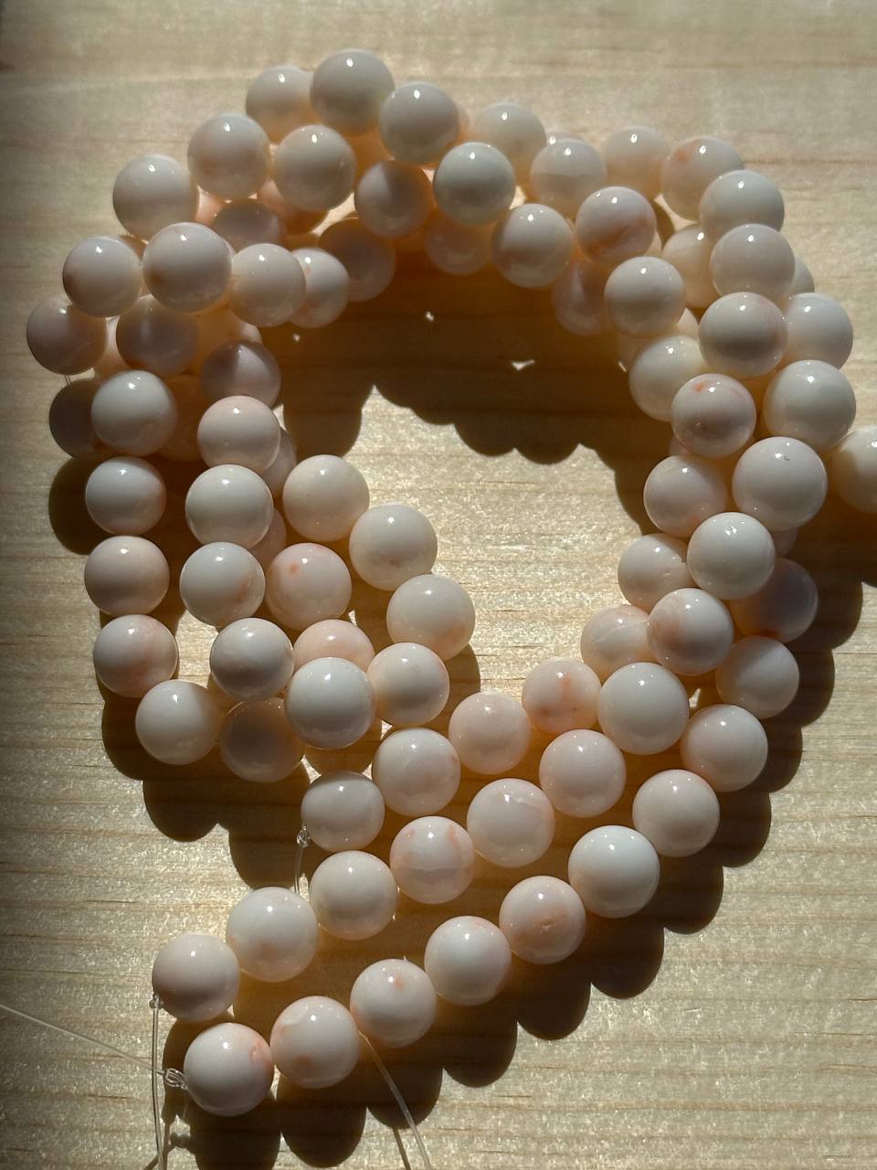 Botswana agate beads on wooden surface