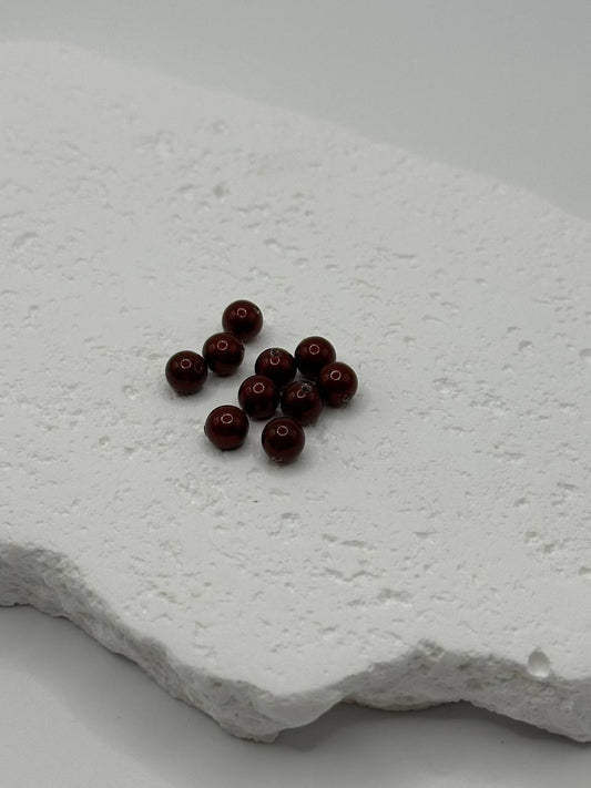 Bordeaux crystal pearls on a textured white surface