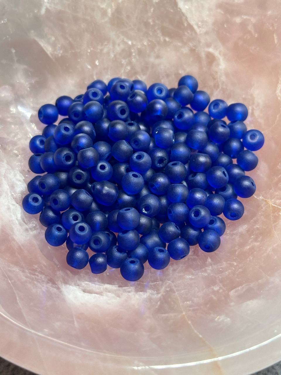 Blue beads on a light brown surface