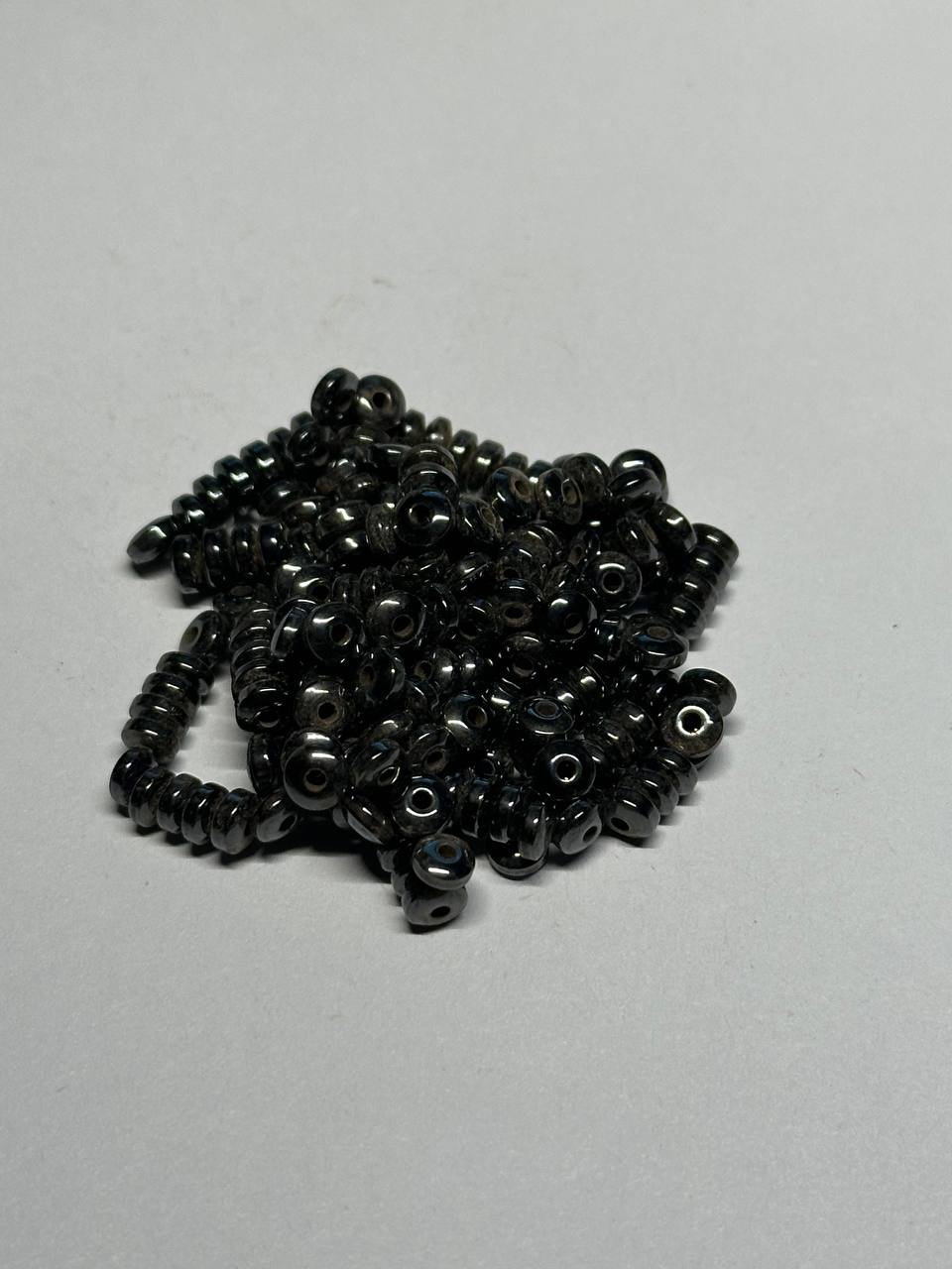 Black hemalyke beads on a light gray background