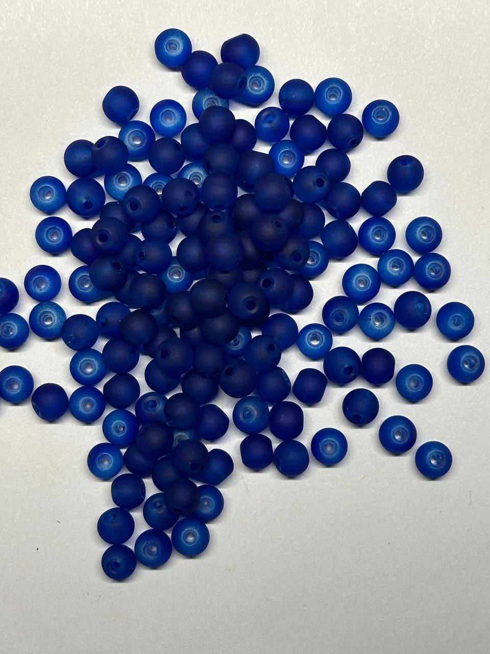 Blue beads scattered on a white background