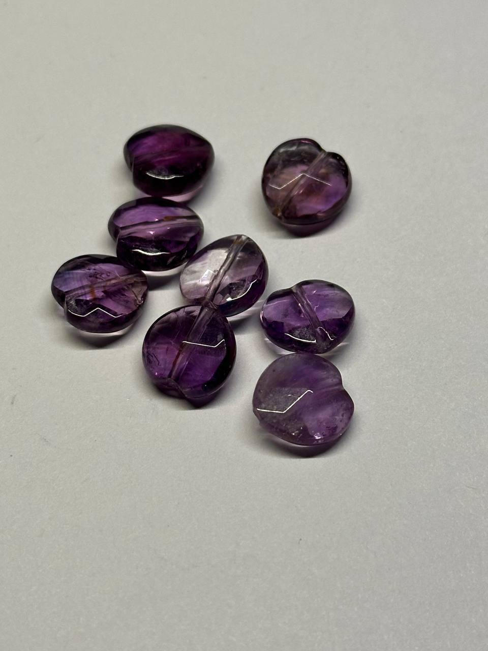 Purple amethyst stones on a light gray background