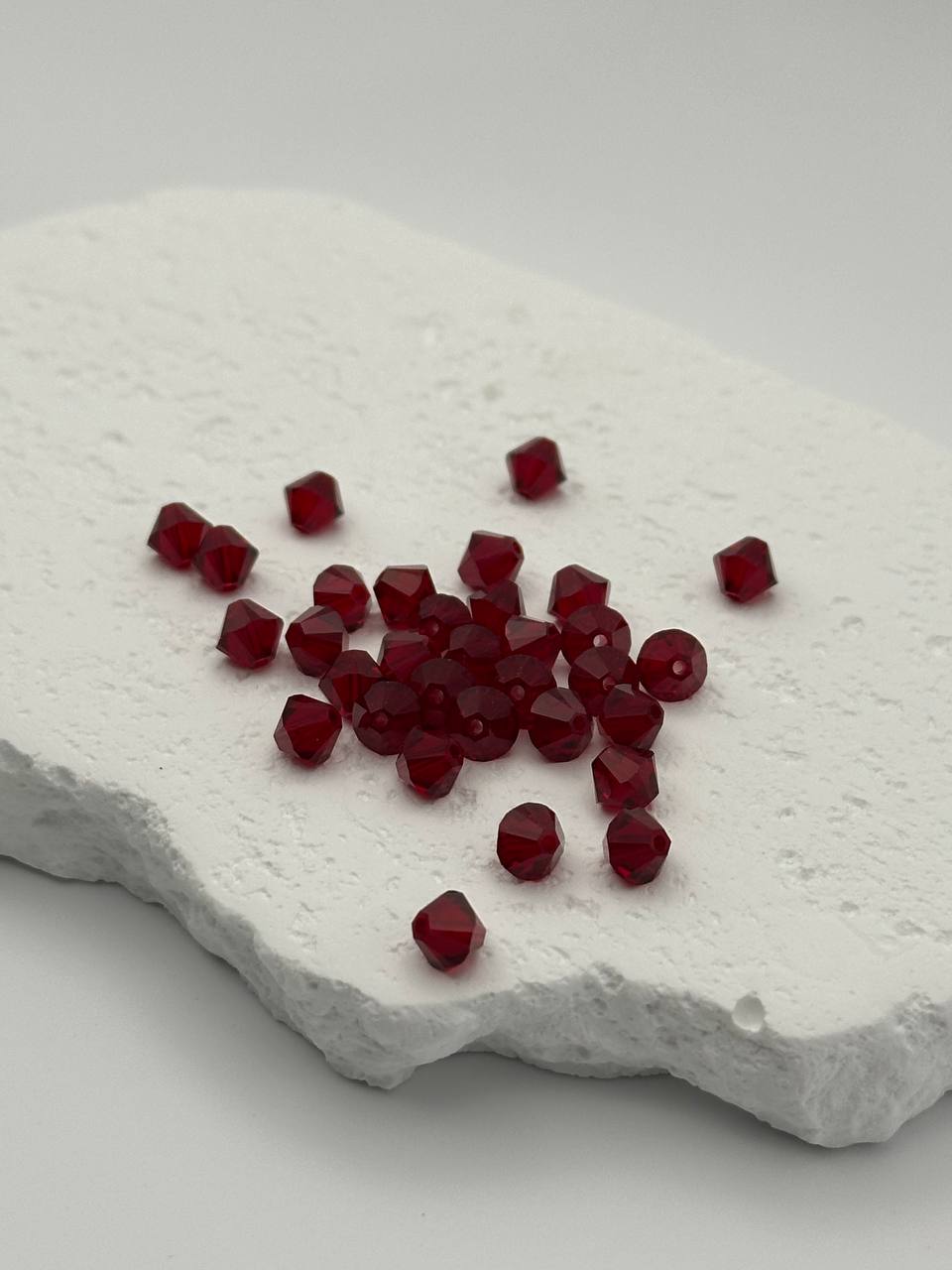 Red beads on a textured white surface