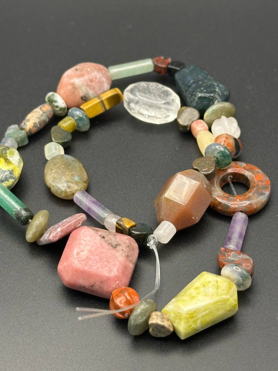 Colorful beaded necklace on a dark surface