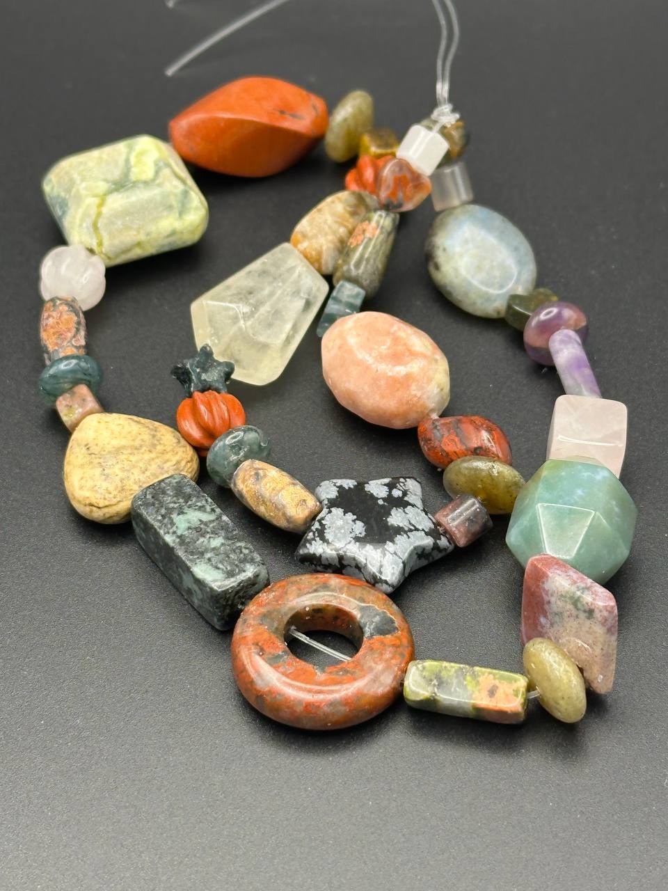 Colorful beaded necklace on a dark surface