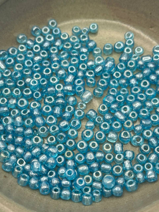 Blue glass beads on a stone surface