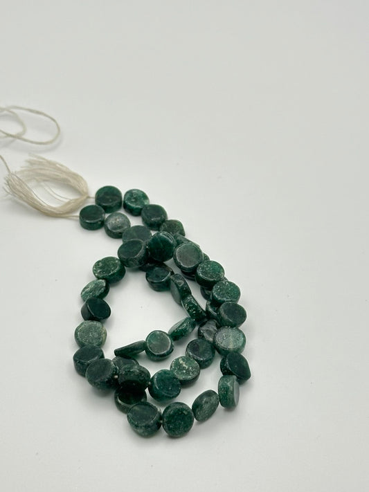 String of green beads on a white background