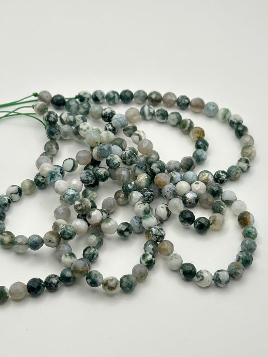 String of multicolored beads on a white background