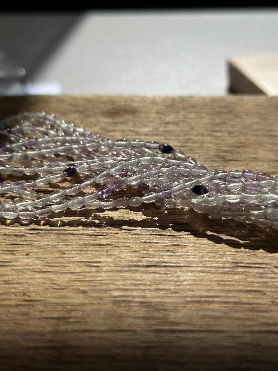 Close-up of a amethyst beads on a wooden surface