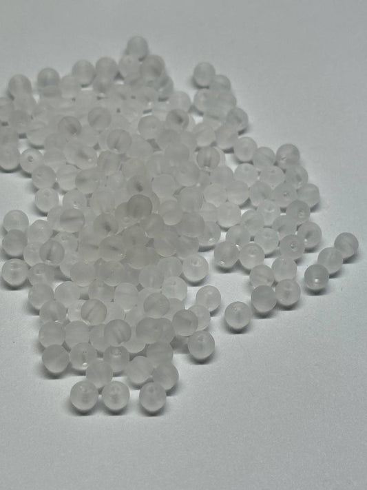 Clear white beads on a gray background