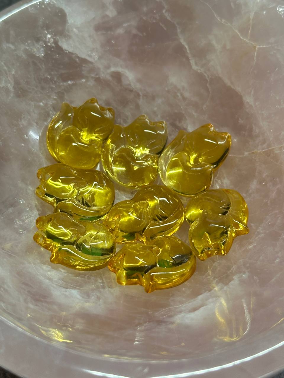 Yellow fox shaped beads on a marble surface