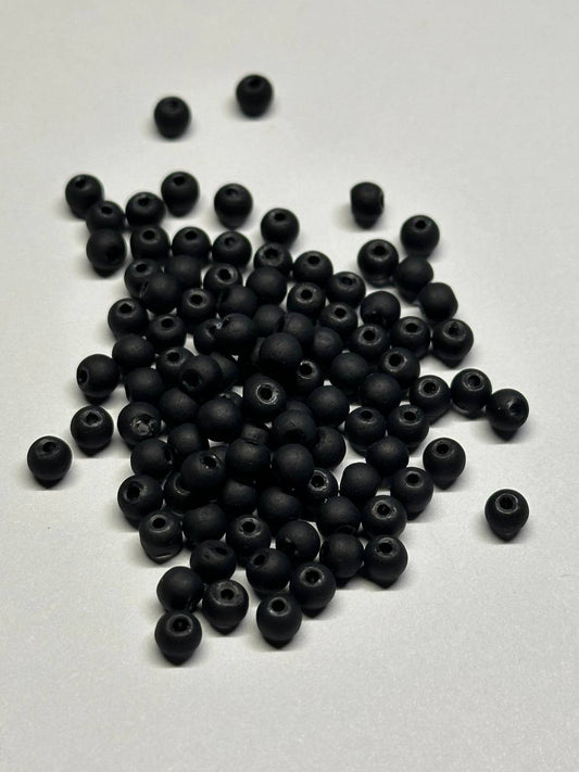 black beads on white surface