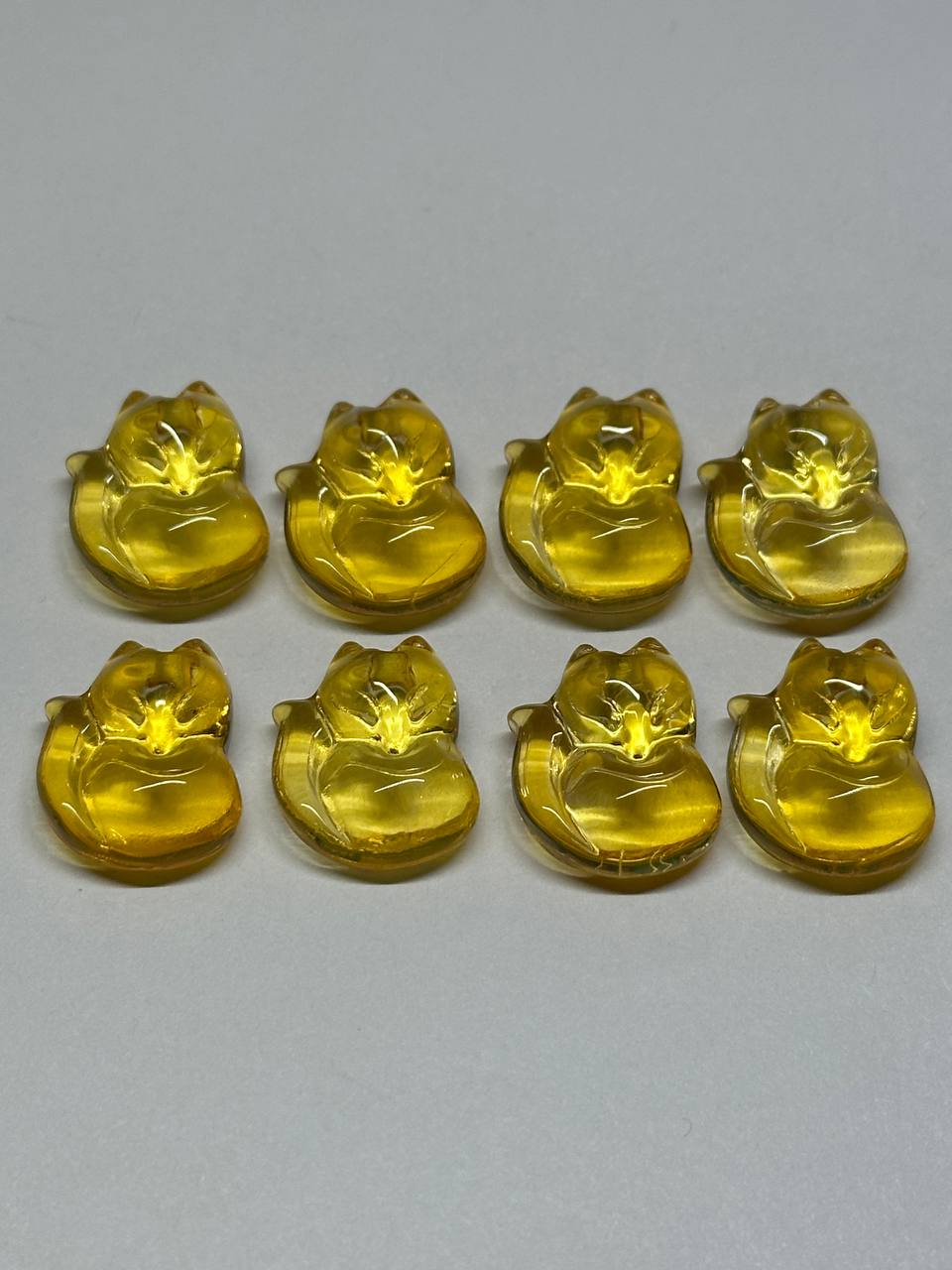 Yellow fox-shaped beads on a gray background