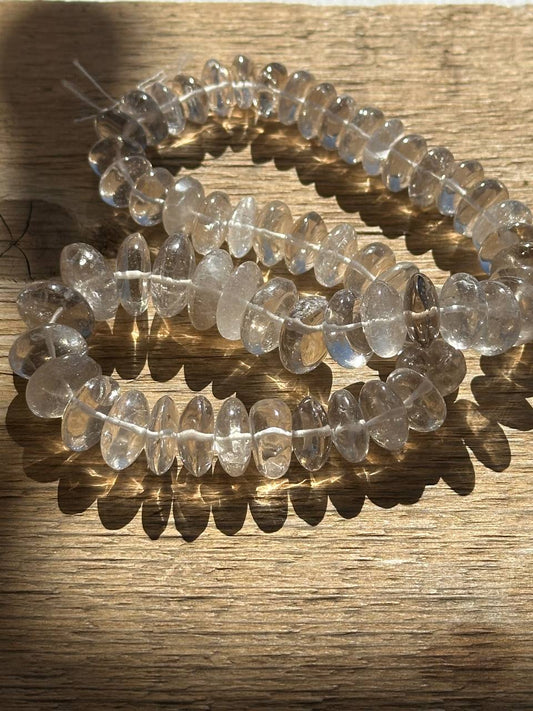 Smoky quartz beads on wooden surface