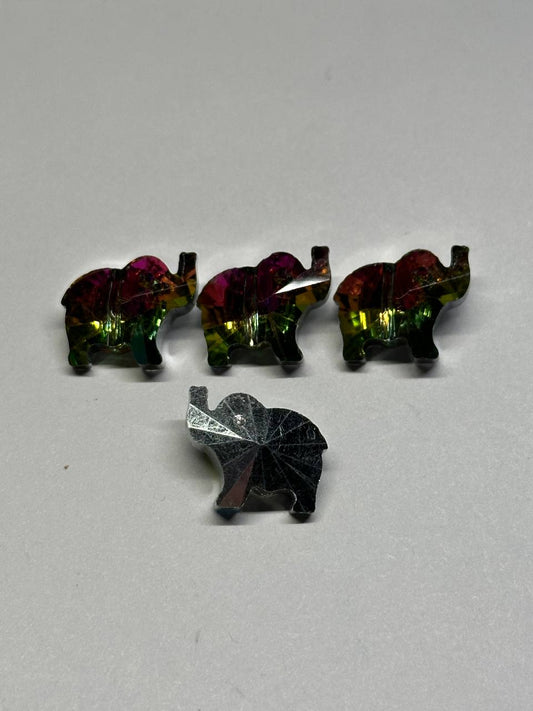 Four multicolored elephant shaped beads on a gray background