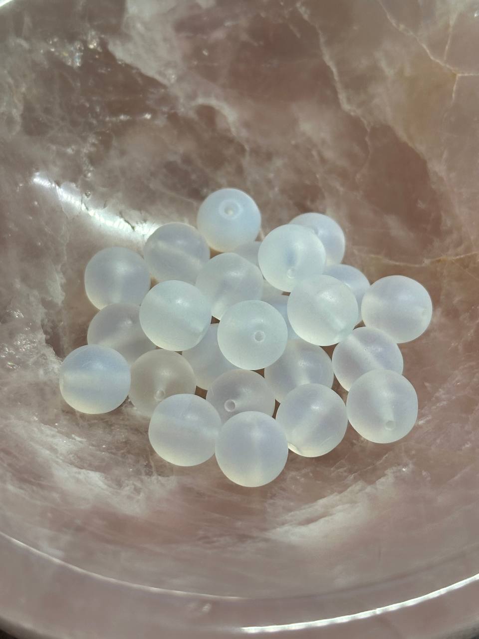 Clear white beads on a marble surface