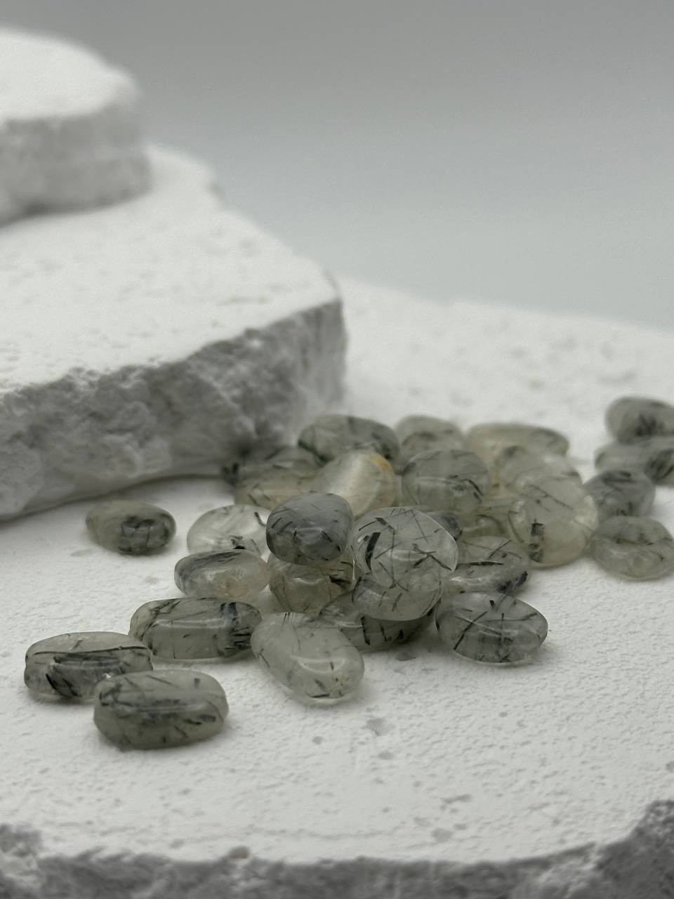 Gray and white stones on a textured surface with a blurred background
