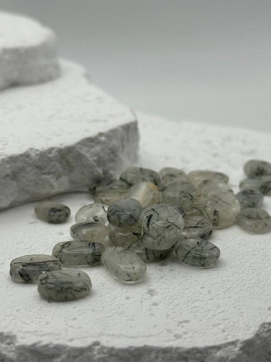 Gray and white stones on a textured surface with a blurred background