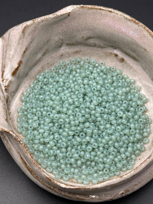 small container filled with green beads