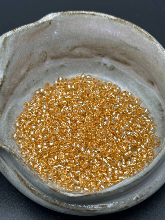 small container filled with gold beads