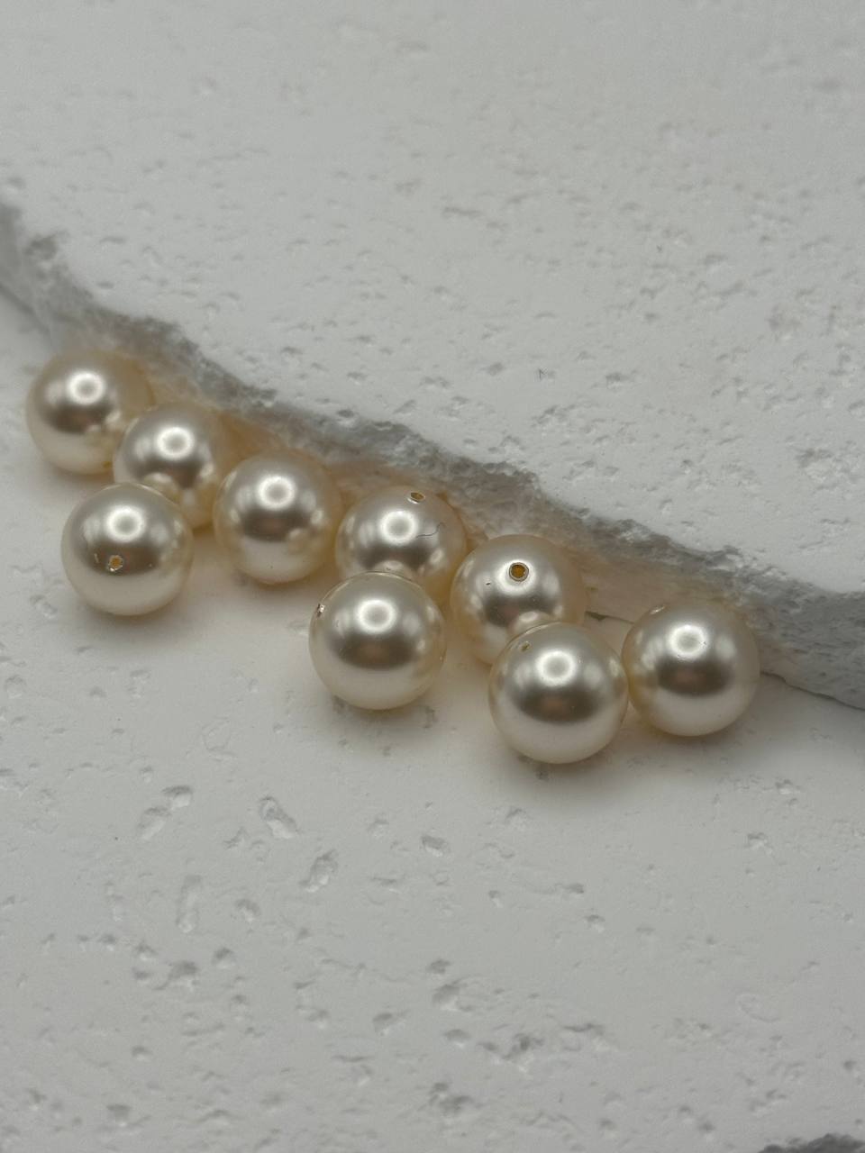 Pearl creamrose beads on a white surface
