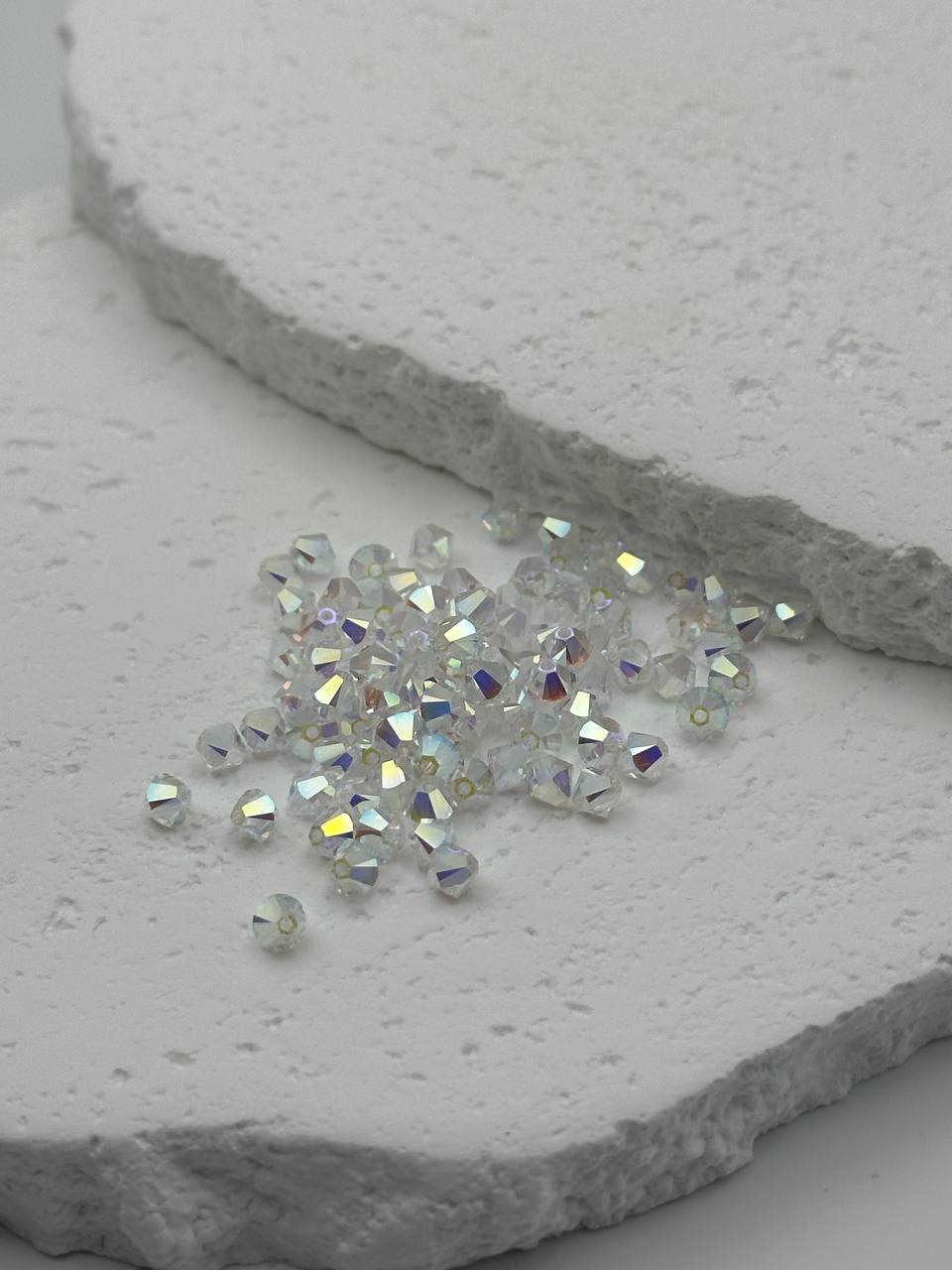 Small bicone crystals on a textured stone surface