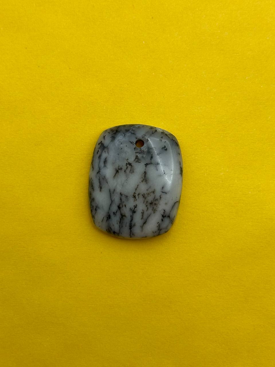 Polished stone on a yellow background