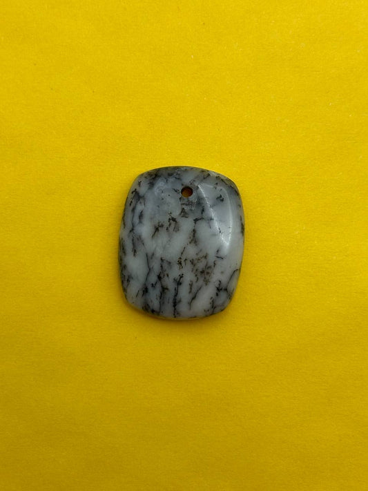 Polished stone on a yellow background
