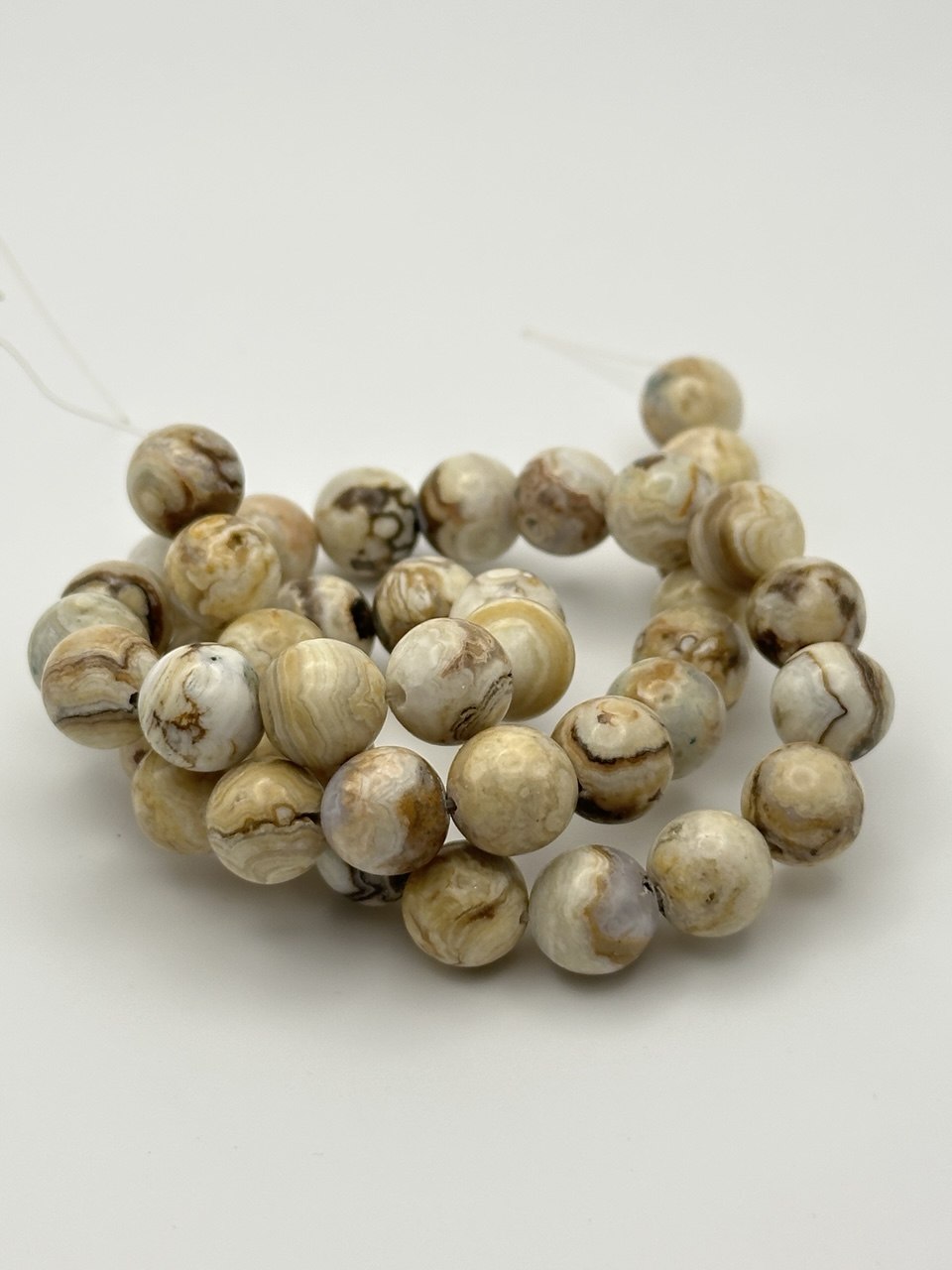 large agate beads on white surface