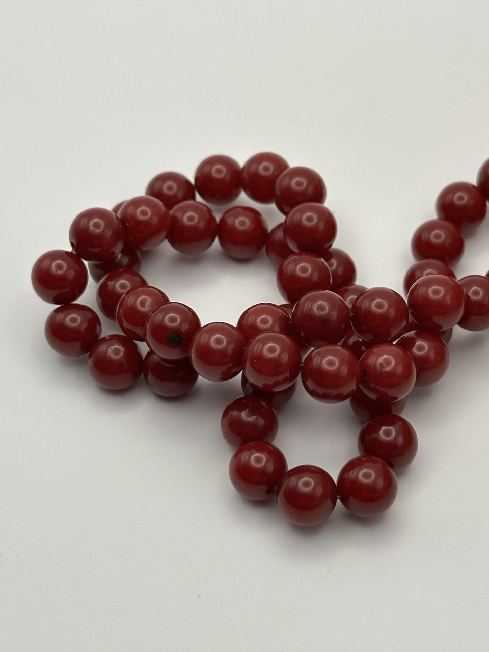 String of red beads on a white background