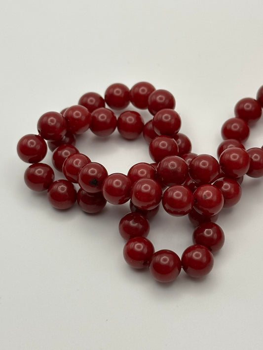 String of red beads on a white background