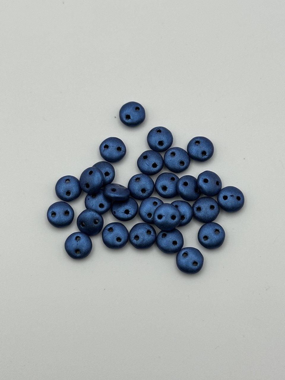 Blue beads on a light gray background