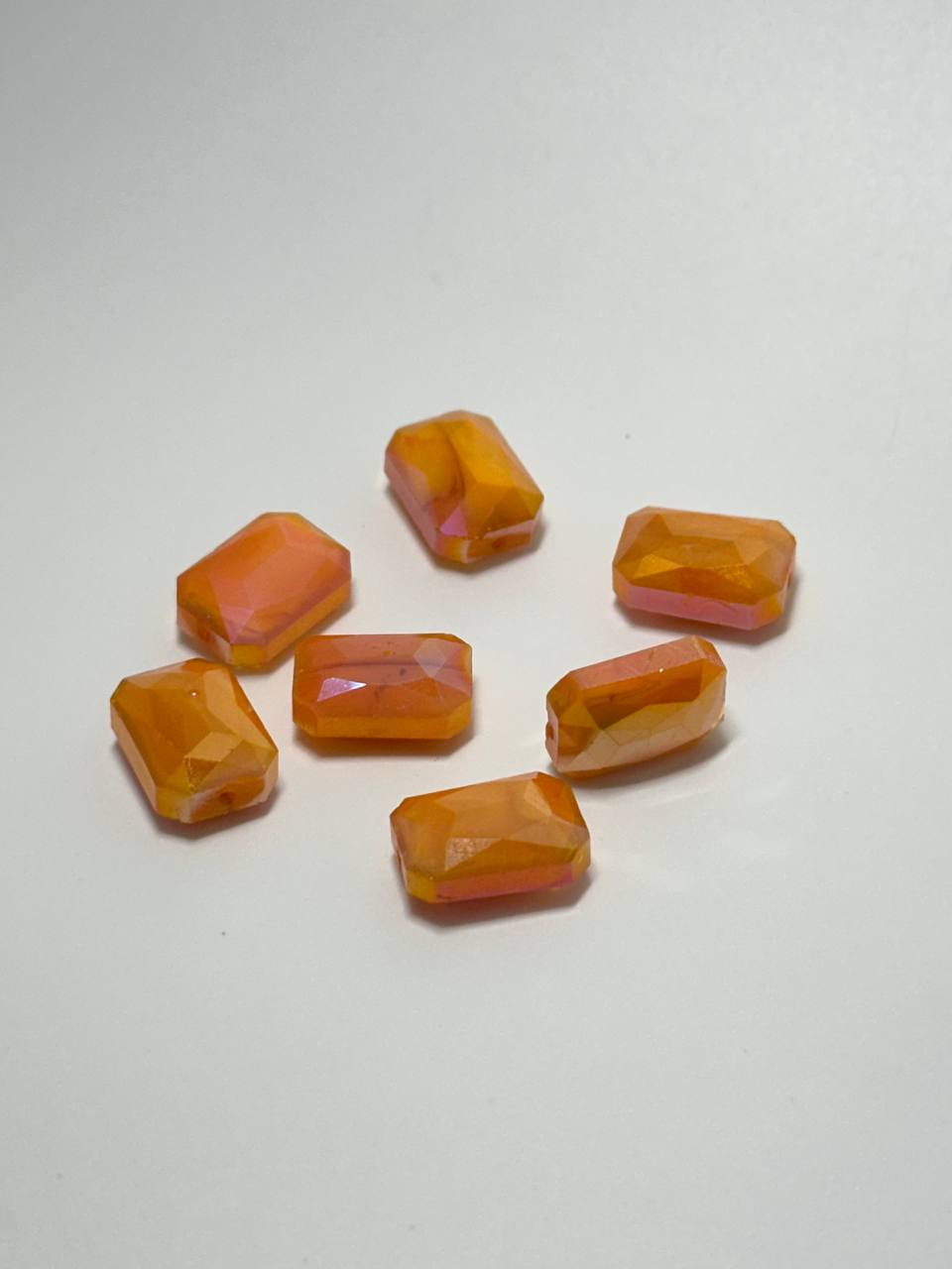 A set of 7 marbled faceted orange AB rounded rectangle acrylic beads