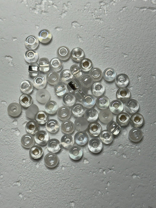 a small pile of crystal white mix e beads in size 2 on white surface