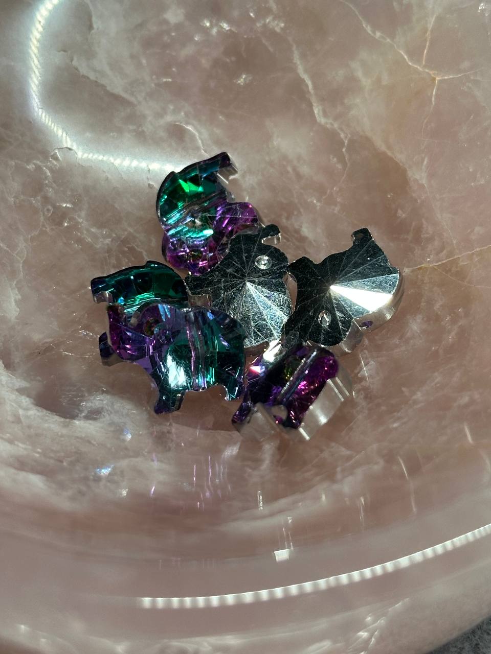 Multicolored elephant shaped beads on a marble surface