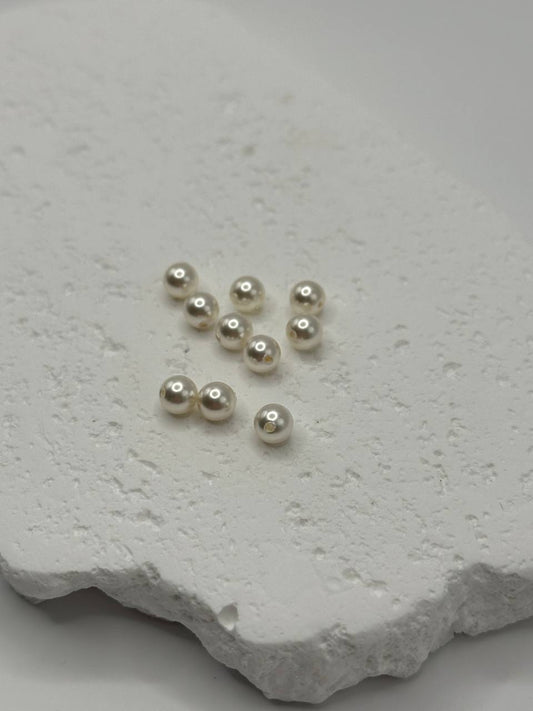 White crystal pearls on a textured white surface