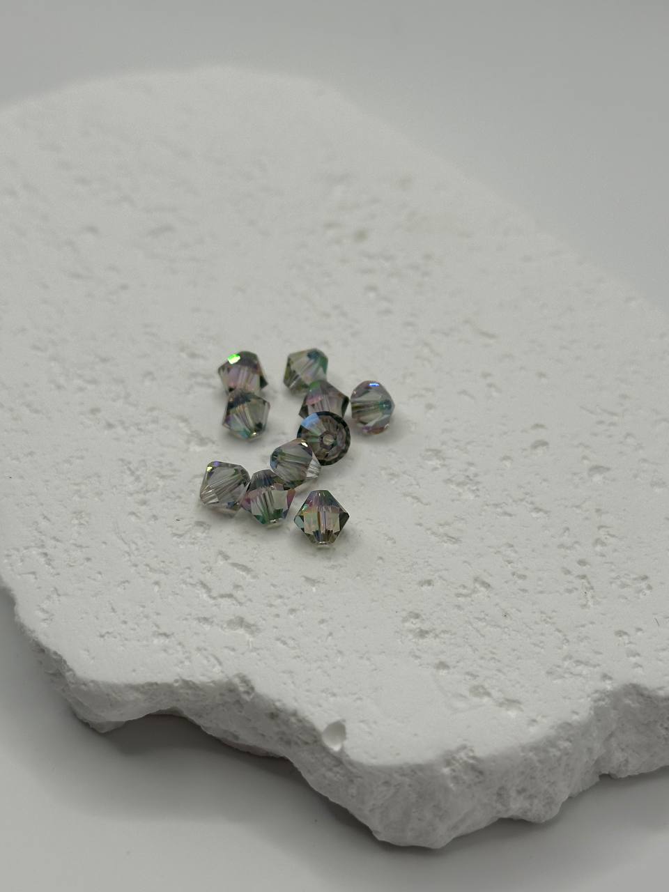 Crystal shiny beads on a textured white surface