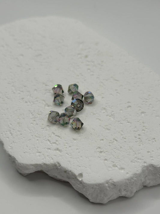 Crystal shiny beads on a textured white surface