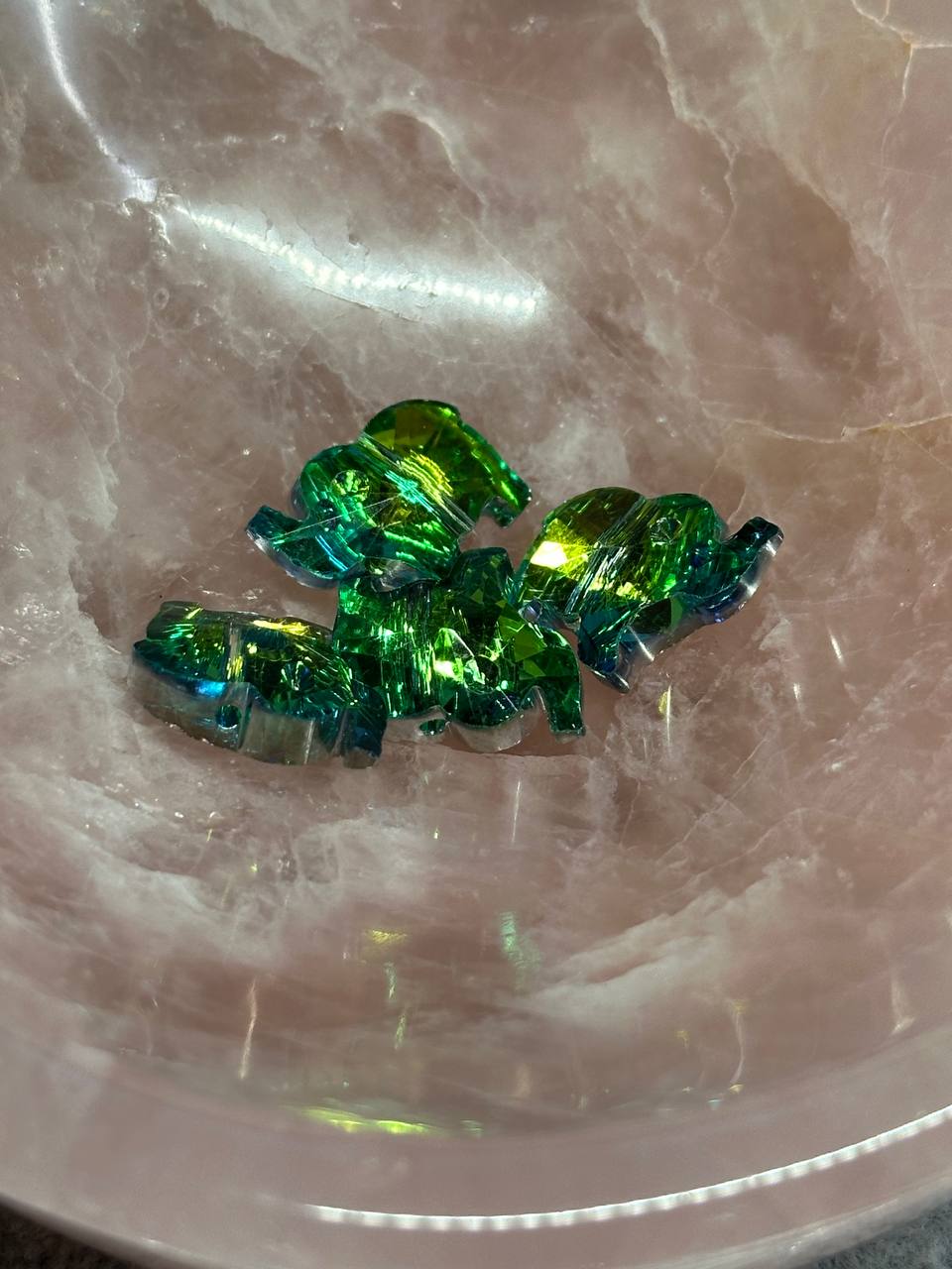 Green crystal-like objects on a reflective surface