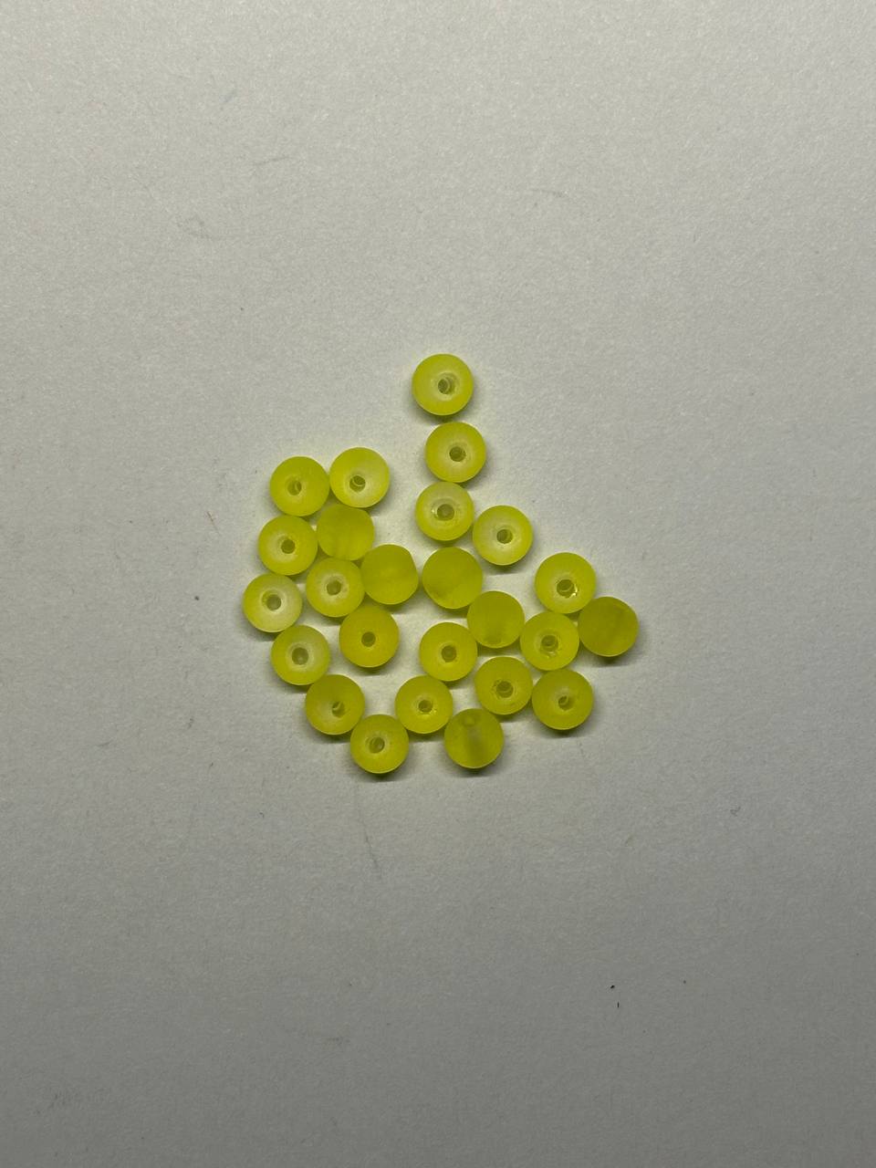 Small lime beads on a light gray background