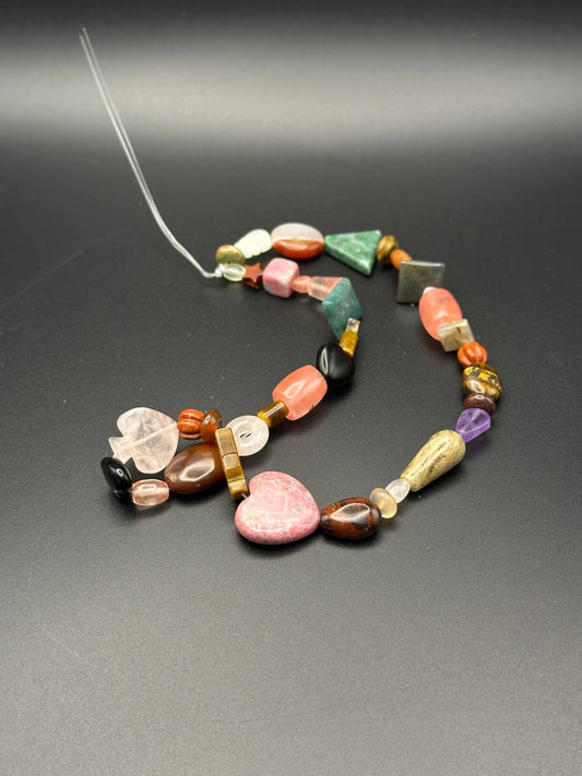 Colorful beaded necklace on a dark gray background